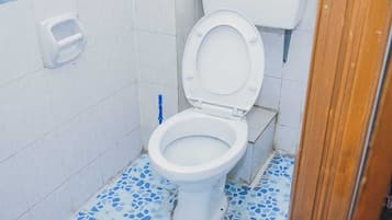 Deluxe Room | Bathroom | Shower, towels, soap, toilet paper