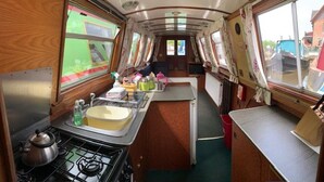 A compact kitchen with a stove, sink, and small countertop. - Stone - Self-drive Boat - Sleeps 8 - Pet Friendly (Stone)