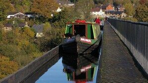 A narrow canal with a narrowboat named "Sutton Ginger" on a bridge. - Stone - Self-drive Boat - Sleeps 8 - Pet Friendly (Stone)