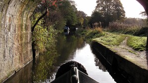 A stone bridge over a calm river with a person in the distance. - Stone - Boat - Sleeps 6 - Pet Friendly - 85ws (Stone)
