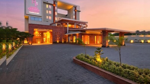 A modern hotel with a central building, a covered outdoor area, and a landscaped entrance. - Regenta Central Shivani Solapur (Mohol)