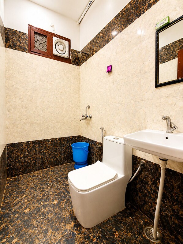 A bathroom with a toilet, sink, and shower. - Hotel Mero Vrindavan (Vrindavan)