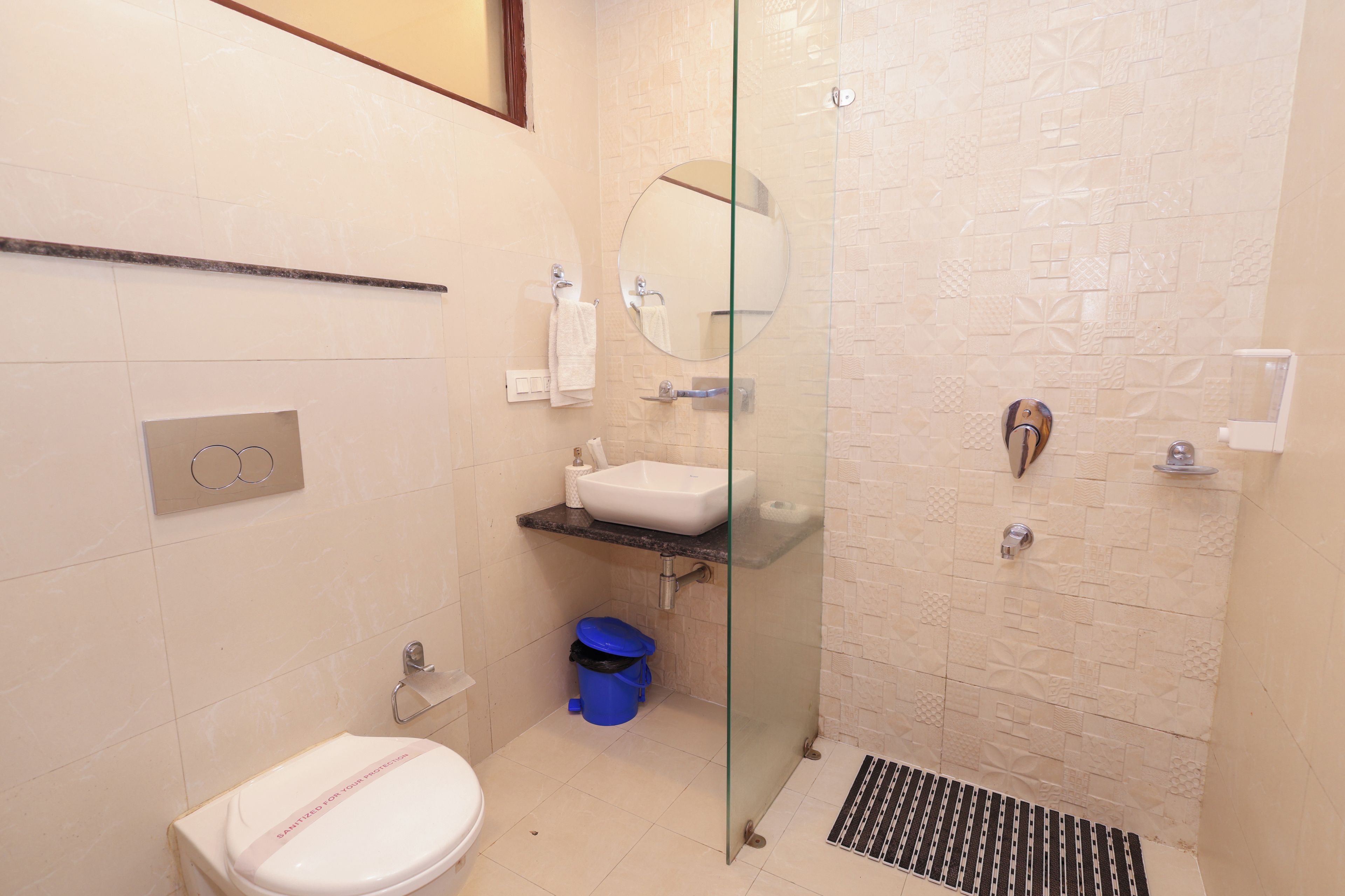A modern bathroom with a toilet, sink, and shower area.