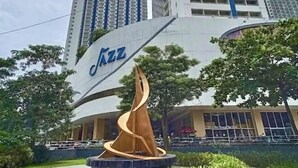 A building with a large 'Jazz' sign and a spiral sculpture in front.