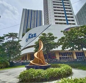 A building with a large 'Jazz' sign and a spiral sculpture in front.