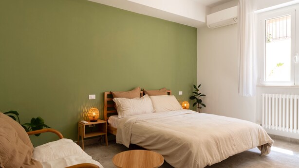 A bedroom with a bed, bedside tables, a chair, and a small round table. - Just minutes from downtown and the beach, elegant BnB in Sirolo (Sirolo)