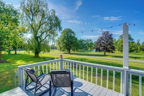 A wooden deck with two chairs, overlooking a well-maintained lawn and trees. - Fire Pit, Deck & Water Views: Athens Home! (Athens)