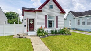 A two-story house with a red roof and white siding, a front porch, and a well-maintained lawn. - Dog-friendly Home w/ Yard, 6 Mi to Louisville! (New Albany)