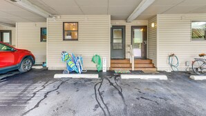 A parking area with a red car, a bicycle, and a welcome sign. - ~ 1 Block to Bethany Beach, Retreat w/ Pool Access (Bethany Beach)
