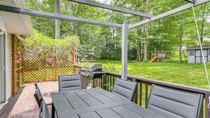 An outdoor patio with a table and chairs, a grill, and a wooden deck. - Patio, 2 Living Rooms, 5 Mi to Beaver Stadium (State College)