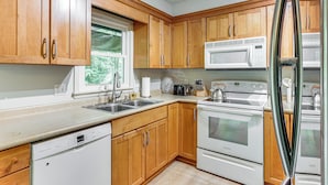 A modern kitchen with wooden cabinets, a dishwasher, a microwave, and two ovens. - Patio, 2 Living Rooms, 5 Mi to Beaver Stadium (State College)