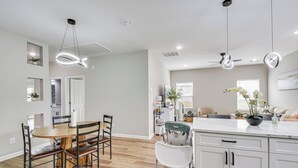 A modern kitchen with a dining area, white cabinetry, and a ceiling fan. - Family Getaway Near Lake Hartwell + Tugaloo Trails (Lavonia)
