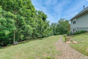 A grassy pathway leading to a house with a sloped roof and a chimney. - 4 Mi to Blue Ridge Parkway: Floyd Studio w/ Yard (Floyd)