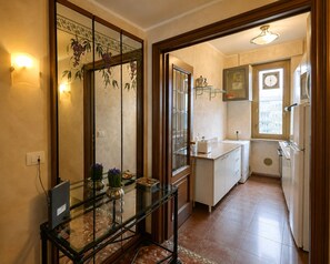 A compact kitchen with a refrigerator, a sink, and a window.
