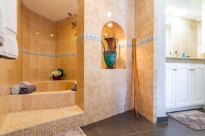 Shower, hair dryer, towels, shampoo