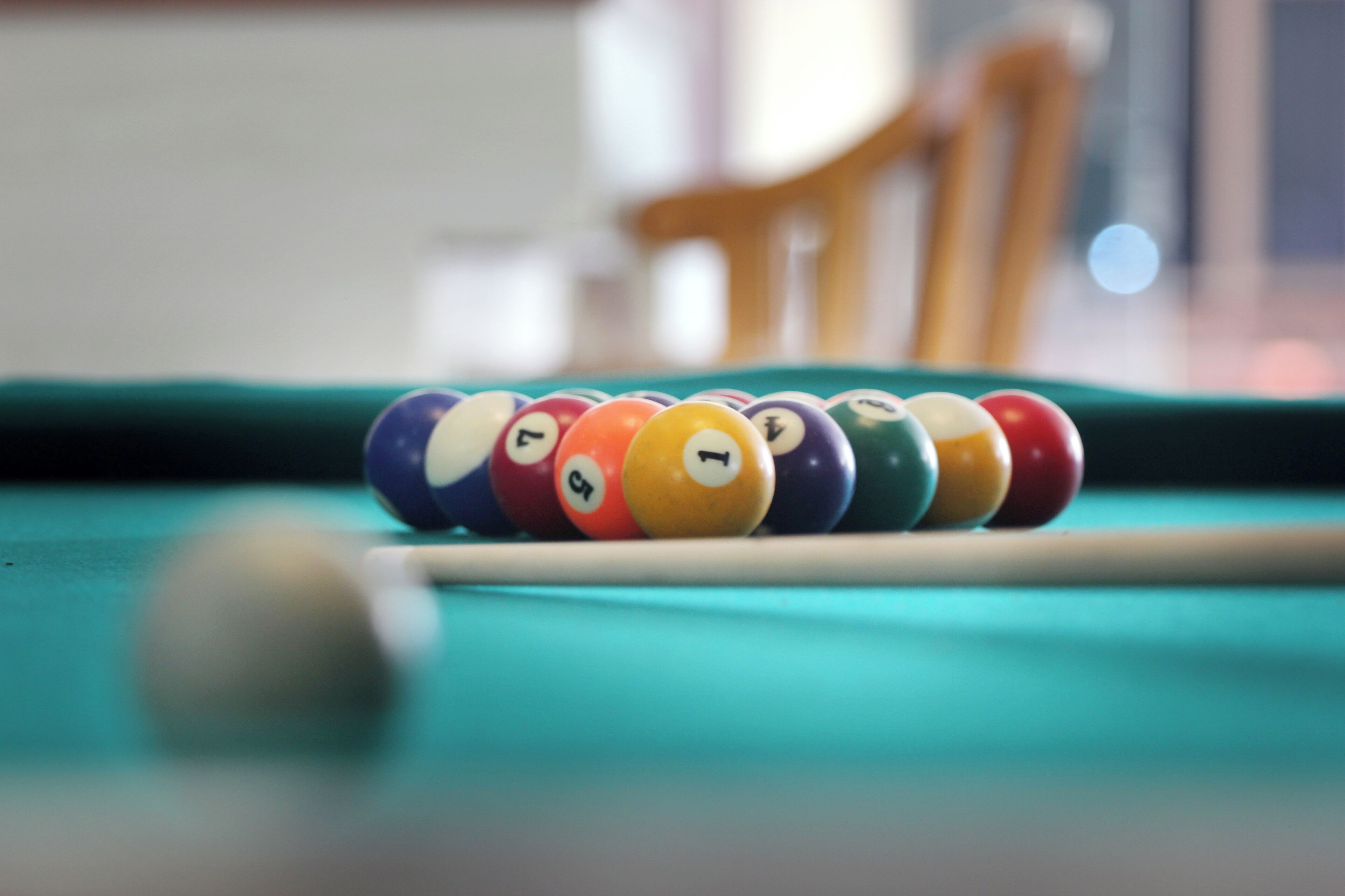 A pool table with a set of numbered billiard balls.