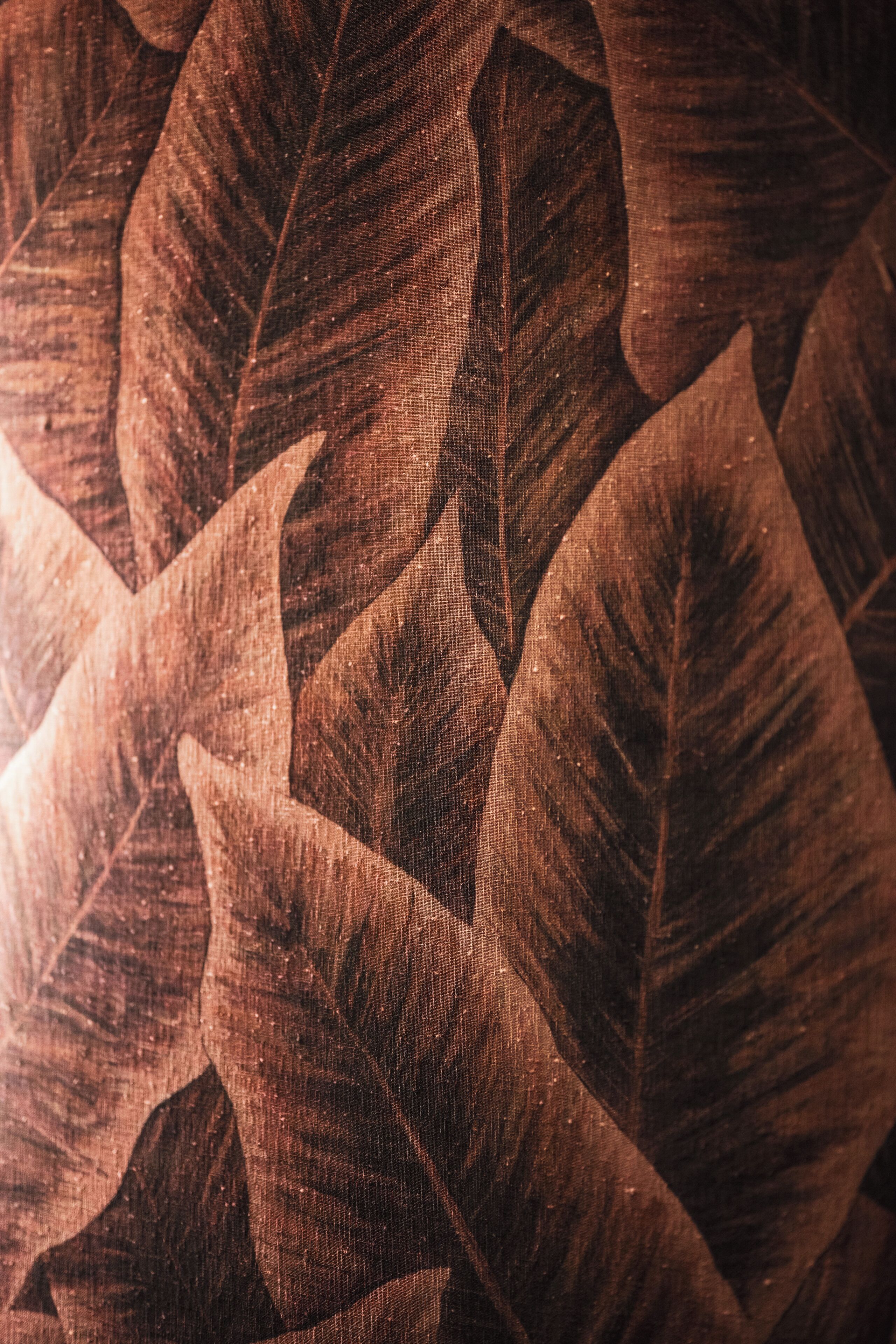 A close-up of a textured fabric with leaf patterns.