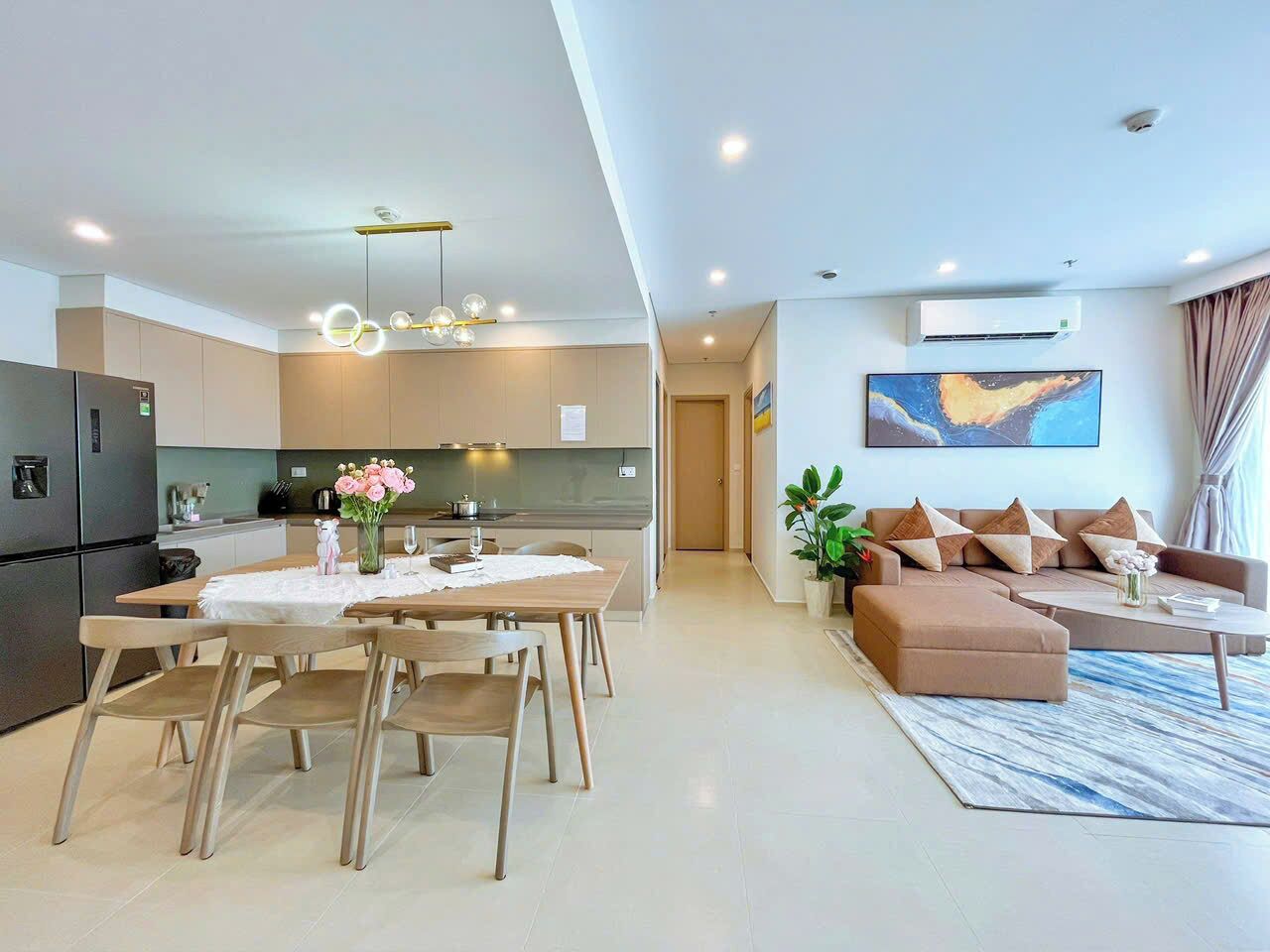 A modern apartment with a kitchen, dining area, and living room.