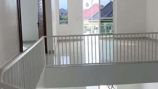 A spacious, multi-level interior with a balcony, large windows, and a modern design. - THE TREKKER'S REST LODGE (Cyuve)