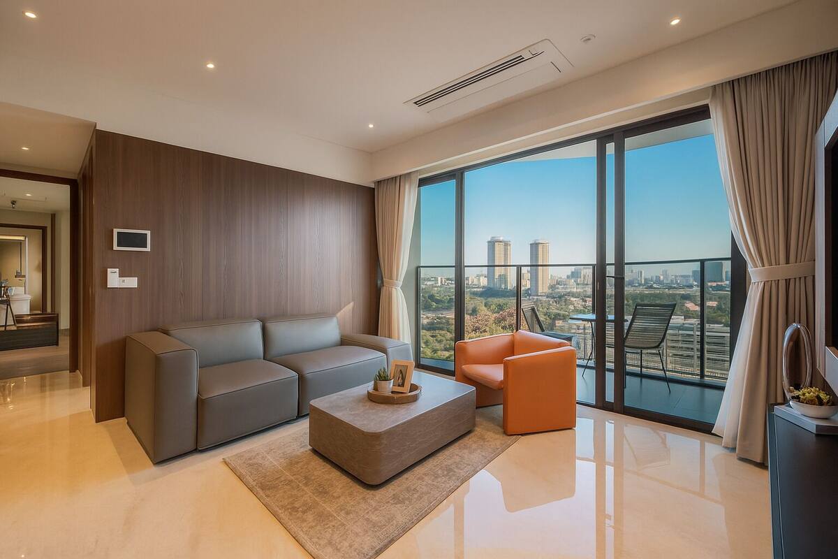 A modern living room with a grey sofa, an orange armchair, and a coffee table.