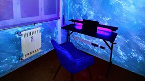 A room with a desk and chair, a radiator, and a window. - Bed and Dreams (Florence)