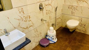 A bathroom with a sink, toilet, and shower.