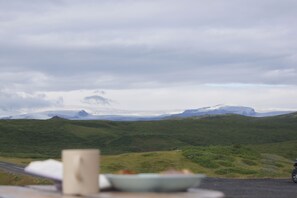 A scenic view of a mountainous landscape with a road in the foreground. - The Fox Hostel (Hrífunesvegur)