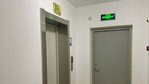 An elevator and a door in a hallway.