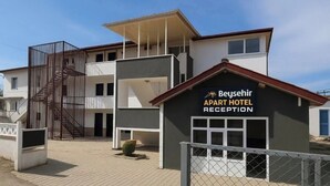 A modern two-story building with a reception area labeled "Beysehir Apart Hotel Reception". - BEYSEHİR APART OTEL (Beysehir)