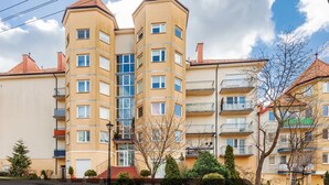 A multi-story residential building with a central tower, balconies, and a clear sky. - Apartment Close to the Beach, Miedzyzdroje (Międzyzdroje)