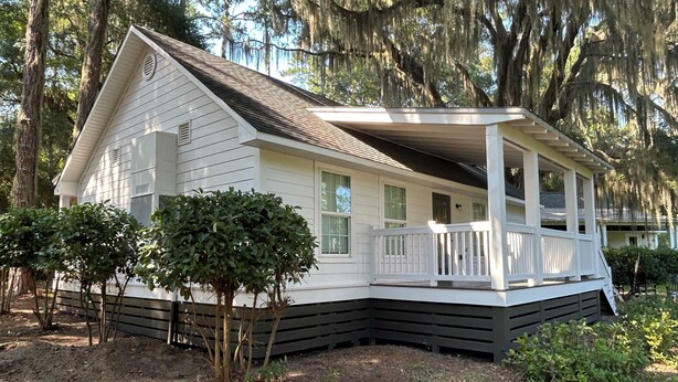 A white house with a porch and a covered front porch area.