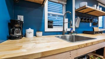 Fridge, microwave, coffee/tea maker, cookware/dishes/utensils