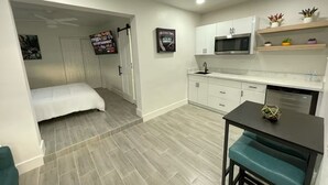 A compact living space with a kitchenette, a bed, and a dining area. - The Vice City Suite•Private Stay+Free Parking in the Heart of Miami (Miami)