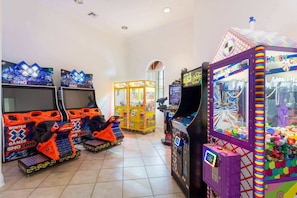 A room with arcade games, including 'Sno Cross' and 'Candy Craft House,' and a colorful claw machine. - Tropical Oasis on Hypolita (Davenport)