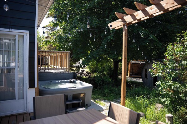 A hot tub on a wooden deck with a pergola overhead. - 3 Bed Waterfront Cottage | Sauna | Hot Tub | Kayak (Tobermory)