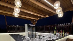 A well-lit bar area with a marble countertop, multiple glasses, and bottles. - Akhnaton Pyramids View (Giza)