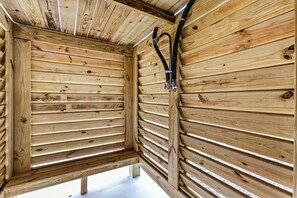 A wooden cabin interior with slatted walls and a bench. - Private Beach Access, Dog-Friendly, Free Cancellation (Bolivar Peninsula)