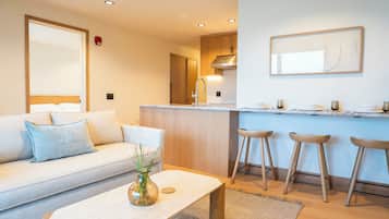 One Bedroom Condo King with Steam Shower | Living area | 55-inch Smart TV with digital channels, Netflix, Hulu