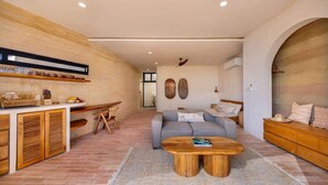 A modern living room with a sofa, coffee table, and wooden cabinets.