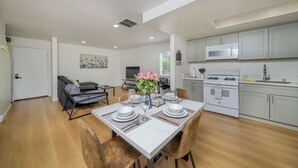 A modern kitchen with white cabinets, a stainless steel microwave, and a white stove. - 2BD/2BA Apartment near DT Alhambra (Alhambra)