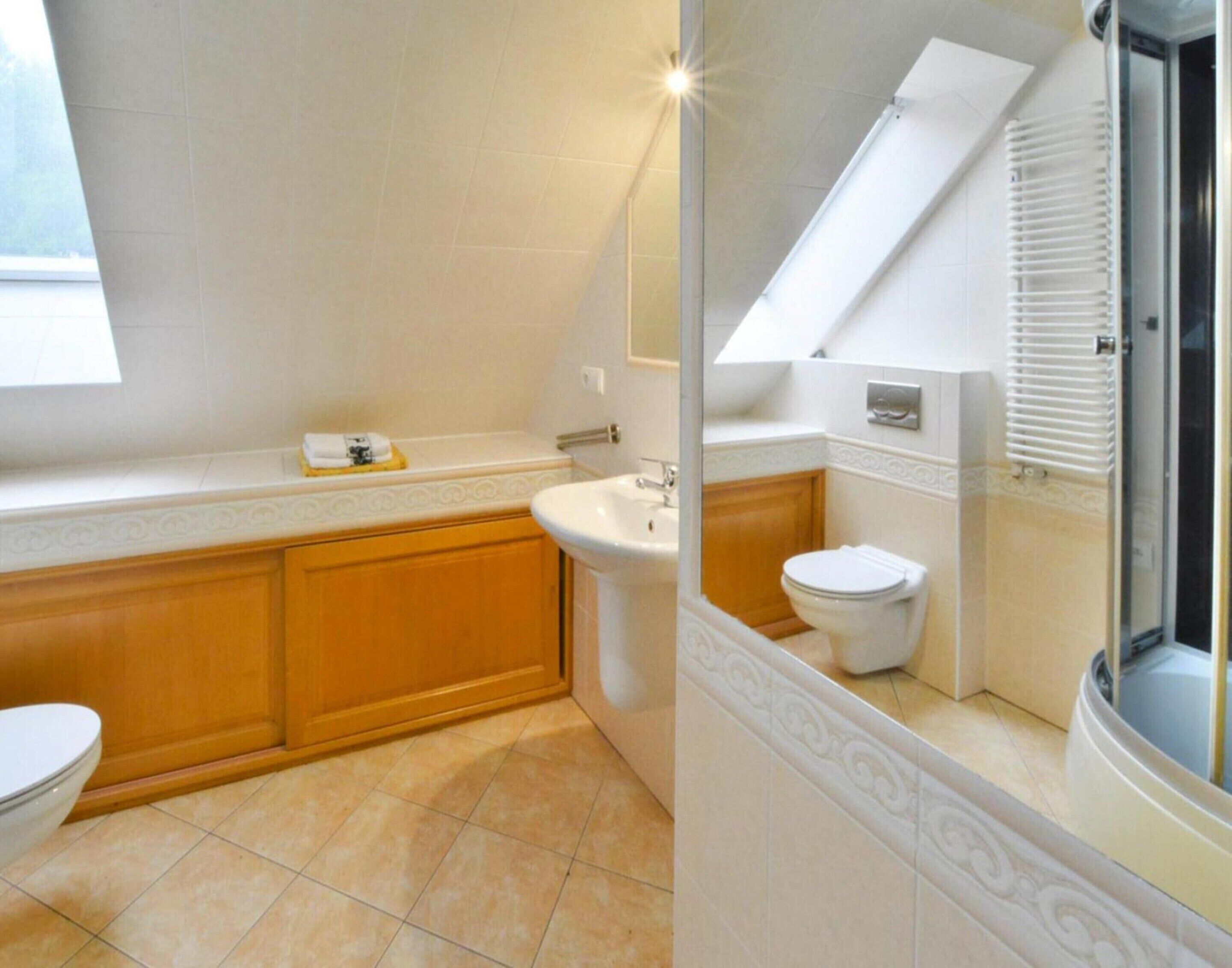 A bathroom with a bathtub, a sink, and a toilet.