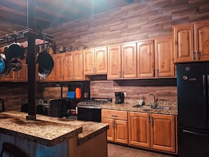 Full-size fridge, oven, cookware/dishes/utensils