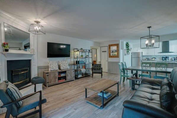 Smart TV, fireplace, books, computer monitors