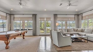 A spacious living room with a pool table, a sofa, and a coffee table. - Experience Ultimate Relaxation: Stunning Lakeside Retreat (Dadeville)