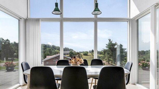 A dining area with a large table and chairs, large windows offering a view of a rural landscape. - "Jonce" - 800m from the sea by Interhome (Ebeltoft)