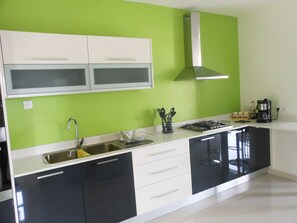 Apartment, 2 Bedrooms, Balcony, Pool View | Private kitchen | Coffee/tea maker, electric kettle, dining tables