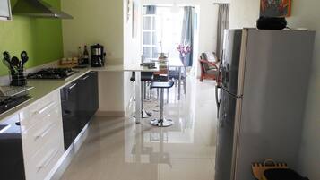 Apartment, 2 Bedrooms, Balcony, Pool View | Private kitchen | Coffee/tea maker, electric kettle, dining tables