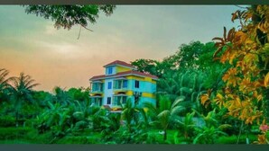 A multi-story house surrounded by lush greenery. - Sukh Sagar Resort (Kaliganj)