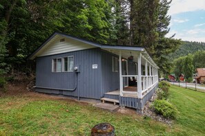 A cabin with a porch, a small window, and a sign indicating it is a cabin.