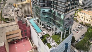 A modern hotel with a rooftop pool, multiple floors, and a glass facade. - Spacious Miami 3BR w/ City & Bay Views (Miami)